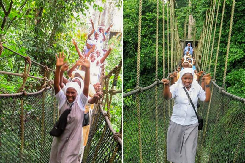 Sisters on the Kakum Canopy Walk in Assin South, Ghana. The canopy walk allows visitors to experience a portion of the jungle usually reserved for climbers and fliers thanks to a trail of precariously hung suspension bridges.