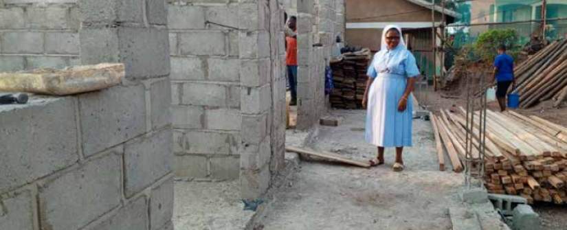 Sr. Furaha at the on-going construction of storied block of a school in Kazo