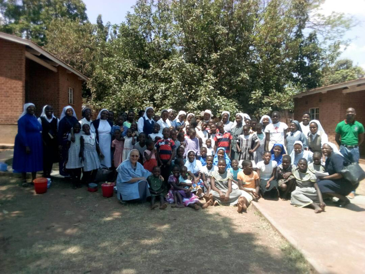 Sisters pose with children from the St. Mary’s Rehabilitation Centre in Chezi, Dowa during the SLDI workshop field trip. At St. Mary's, sisters of Mary Mediatrix are taking care of malnourished children and orphans.