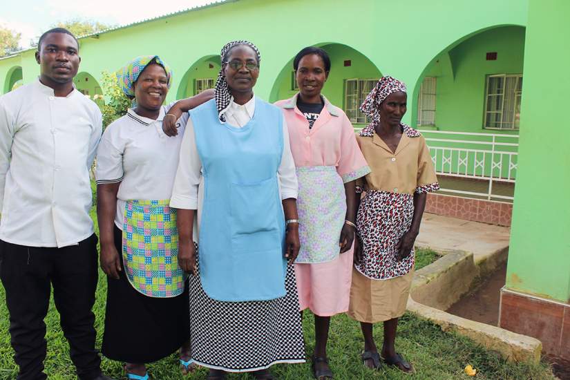 Sr Priscilla Mwanza, center, poses for a photo with the staff at Mt. Zion retreat centre. She's currently an SLDI participant studying Finance.