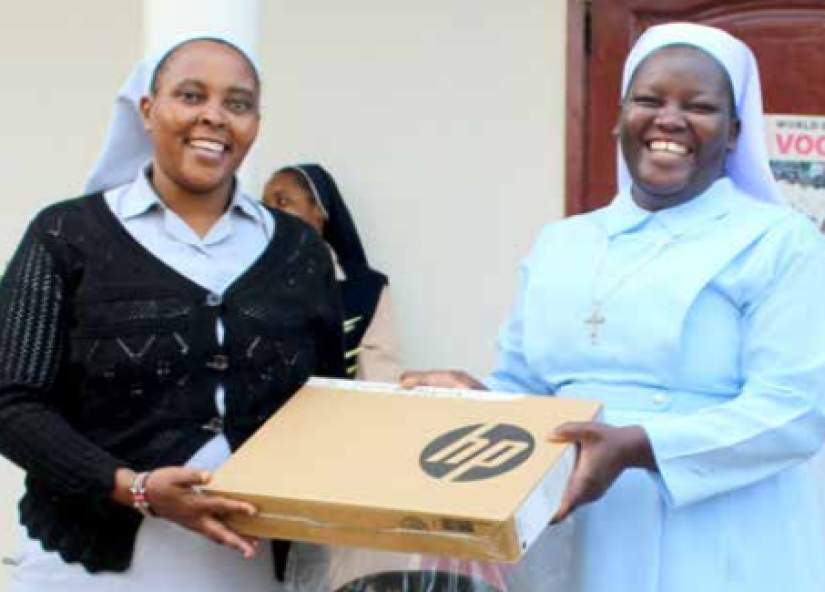 Sr Eunice receives a Laptop from Sr Monica Opige Ajok the Program
Coordinator