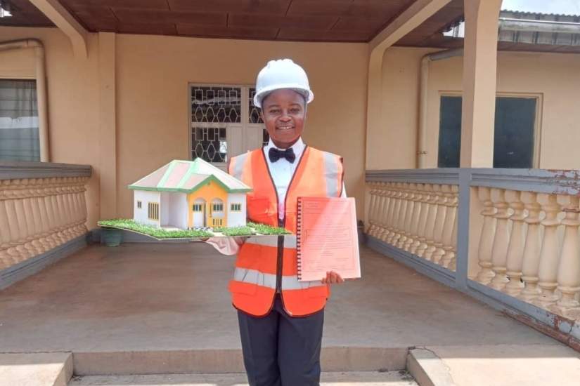 Sr. Wirba Blandine Kinyuy, SSA, holds a model from one of her civil engineering projects, reflecting the technical training she gained with the help of ASEC’s Scholarship Program.