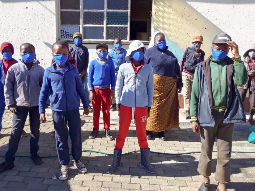 Sr. Theresia Noko stands with boys who are beneficiaries of her educational COVID-19 workshop. The boys also received masks that were sewed by the Sisters of Charity of Ottawa (SCO) in Lesotho.