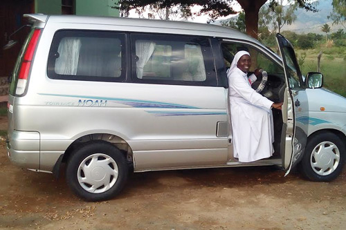 Sr. M. Tryphina Buchard, STH, ASEC Director in Tanzania, behind the wheel of her van.