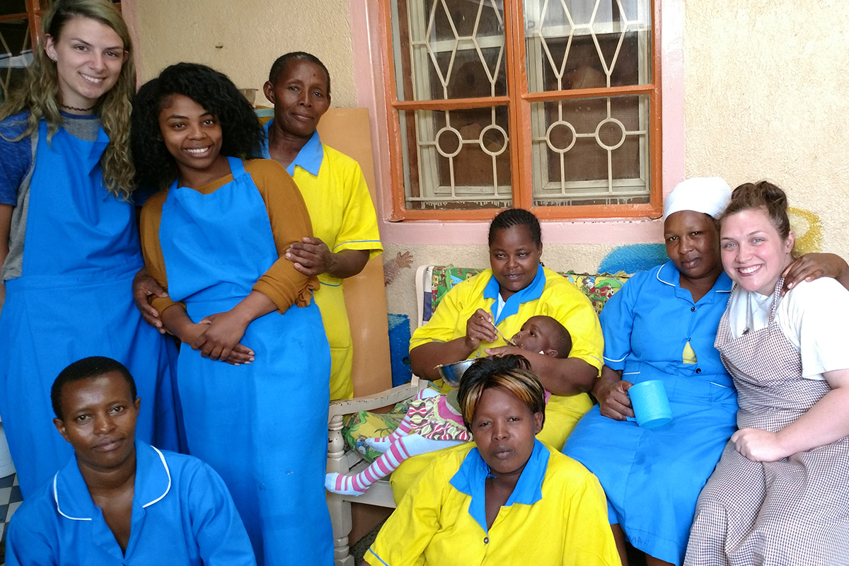 Students take a group photo with the staff from the Mother Theresa Orphanage